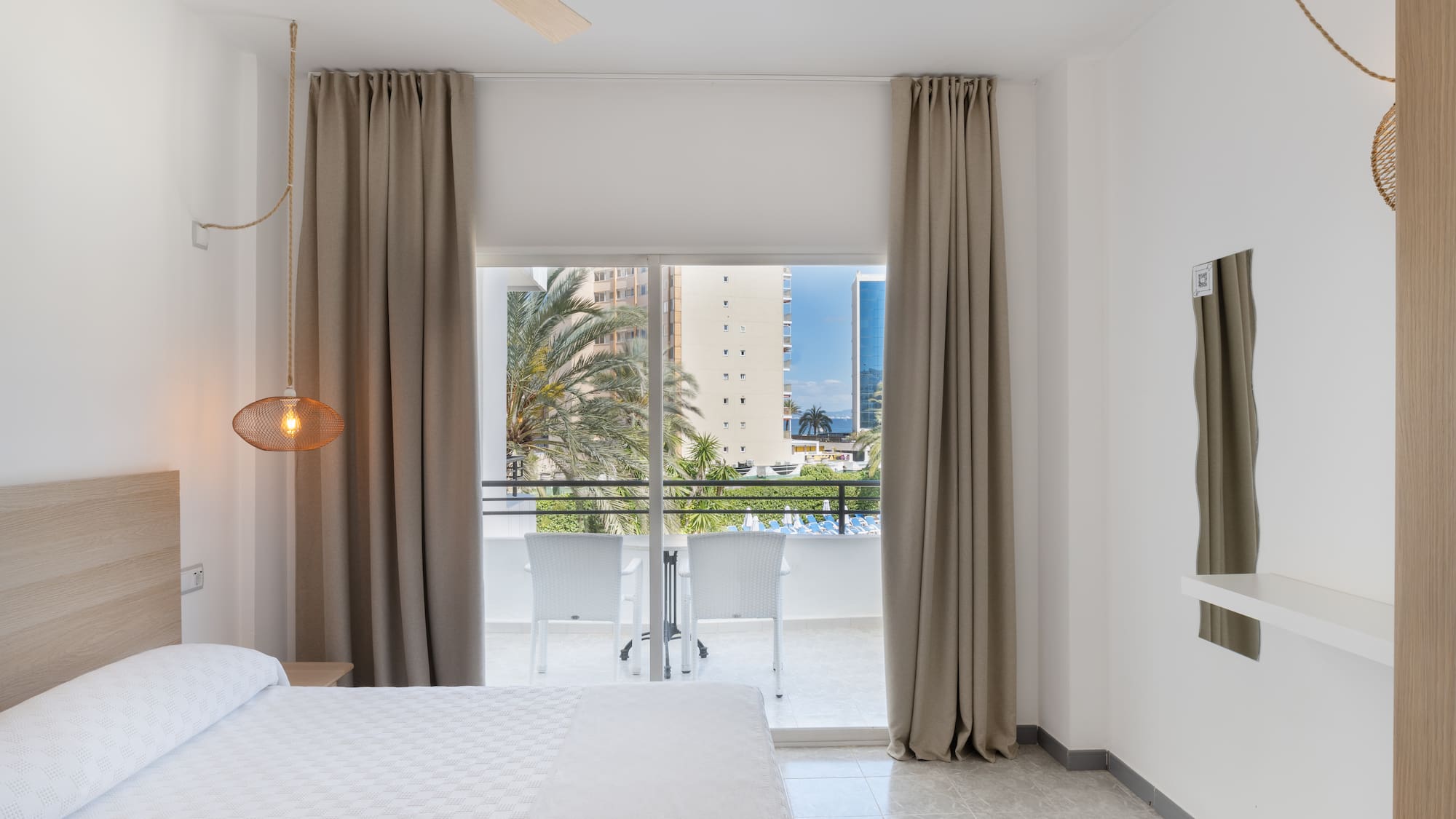 a bedroom with a bed and a ceiling fan