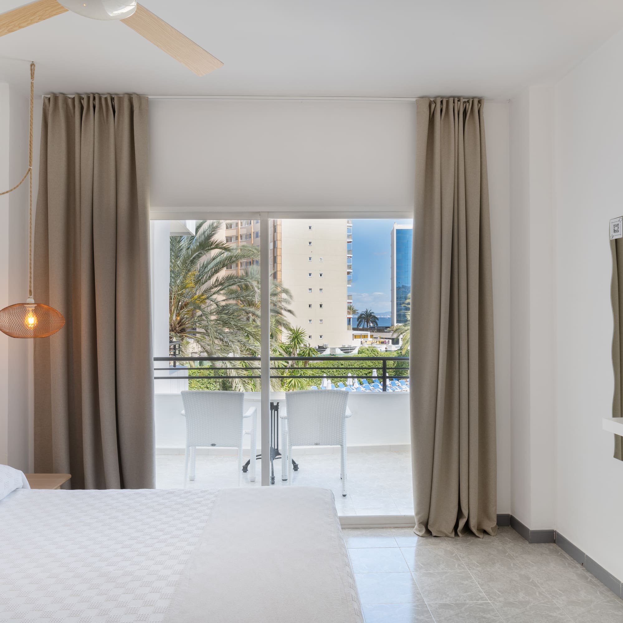 a bedroom with a bed and a ceiling fan