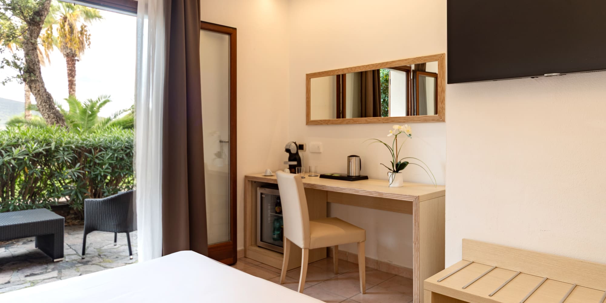 a room with a bed and a television