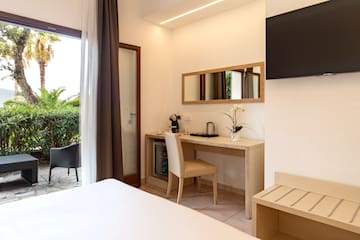 a room with a bed and a television