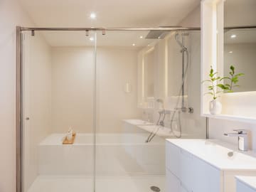 a bathroom with a glass shower door