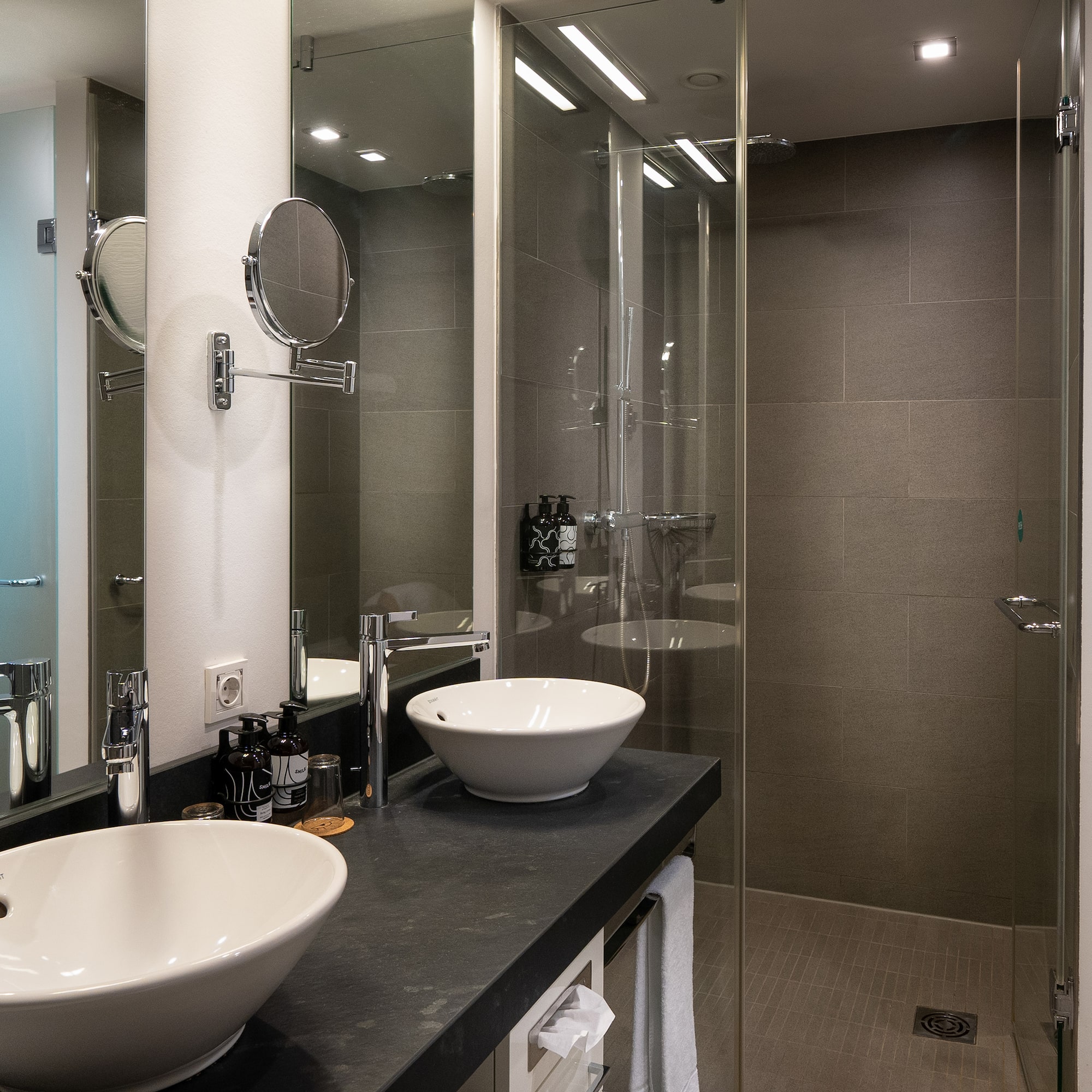 a bathroom with two sinks and a shower