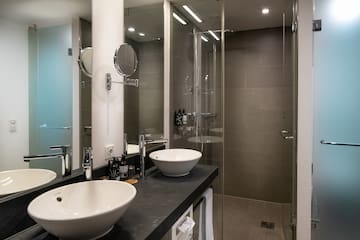 a bathroom with two sinks and a shower