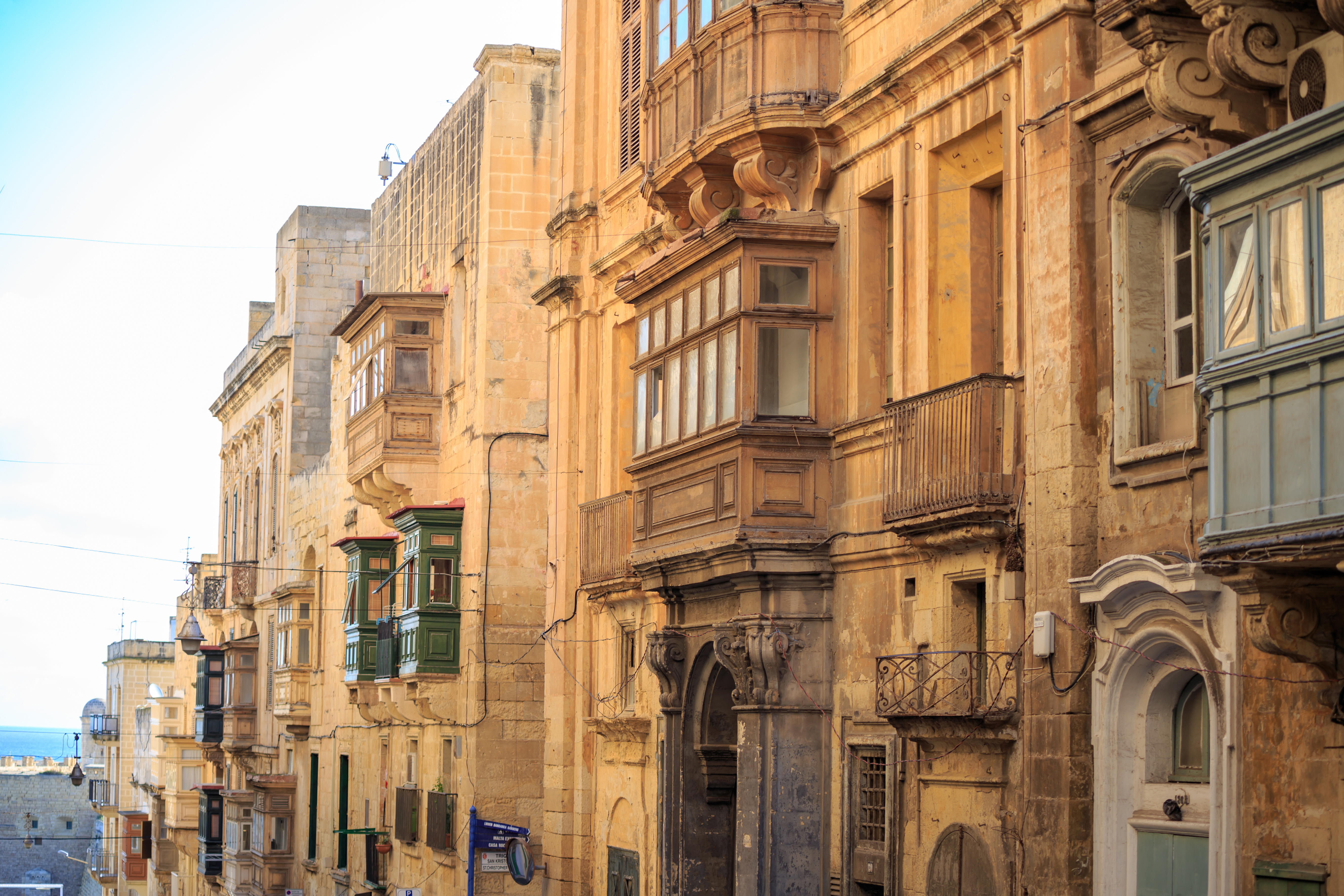 Traditional Maltese balconies on historic stone buildings in Valletta, Malta.