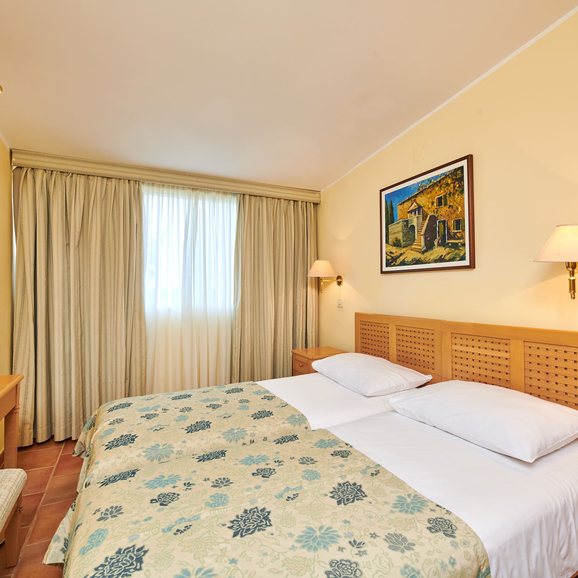 a bed with a wood headboard and a lamp on the wall