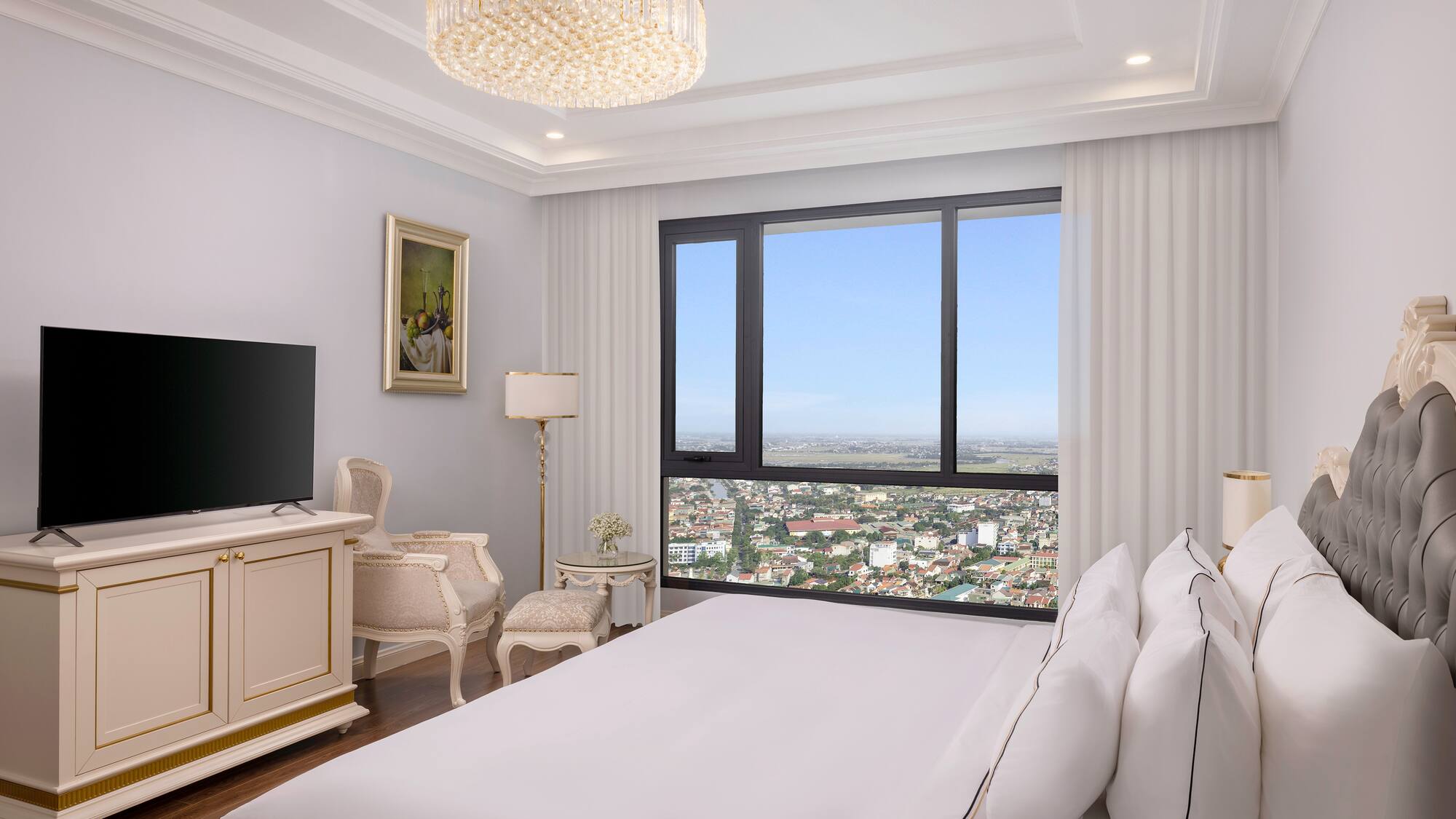 a bedroom with a large window and a large bed