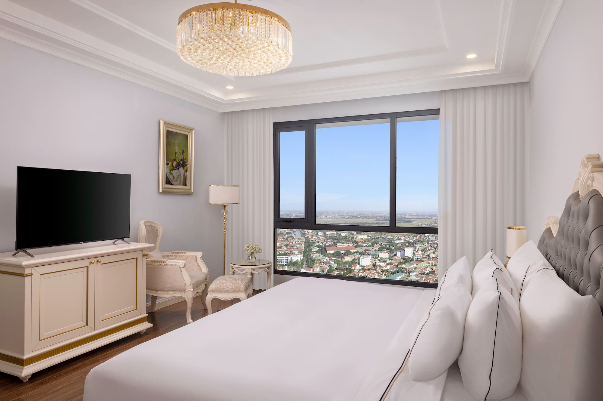 a bedroom with a large window and a large bed