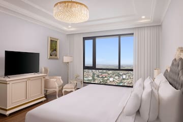 a bedroom with a large window and a large bed