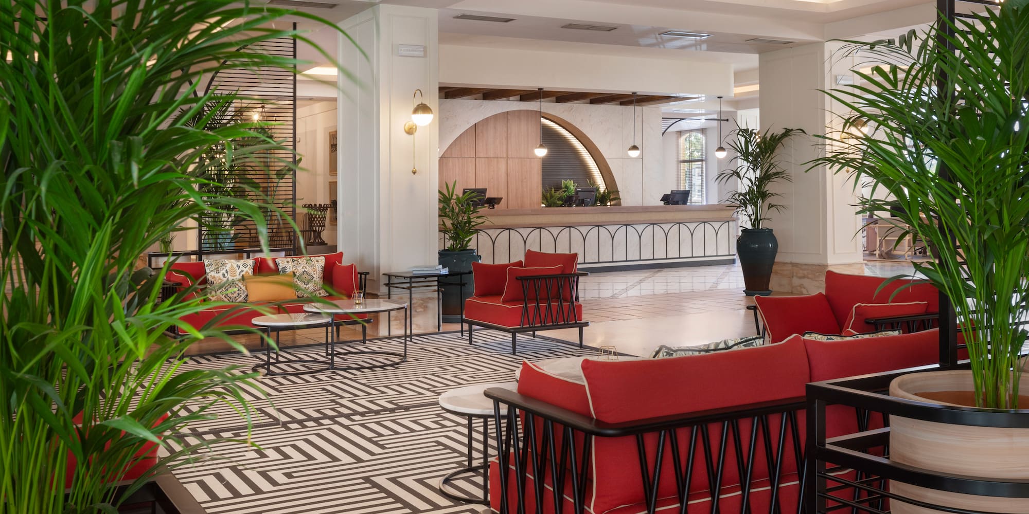 a room with red couches and a black and white patterned floor