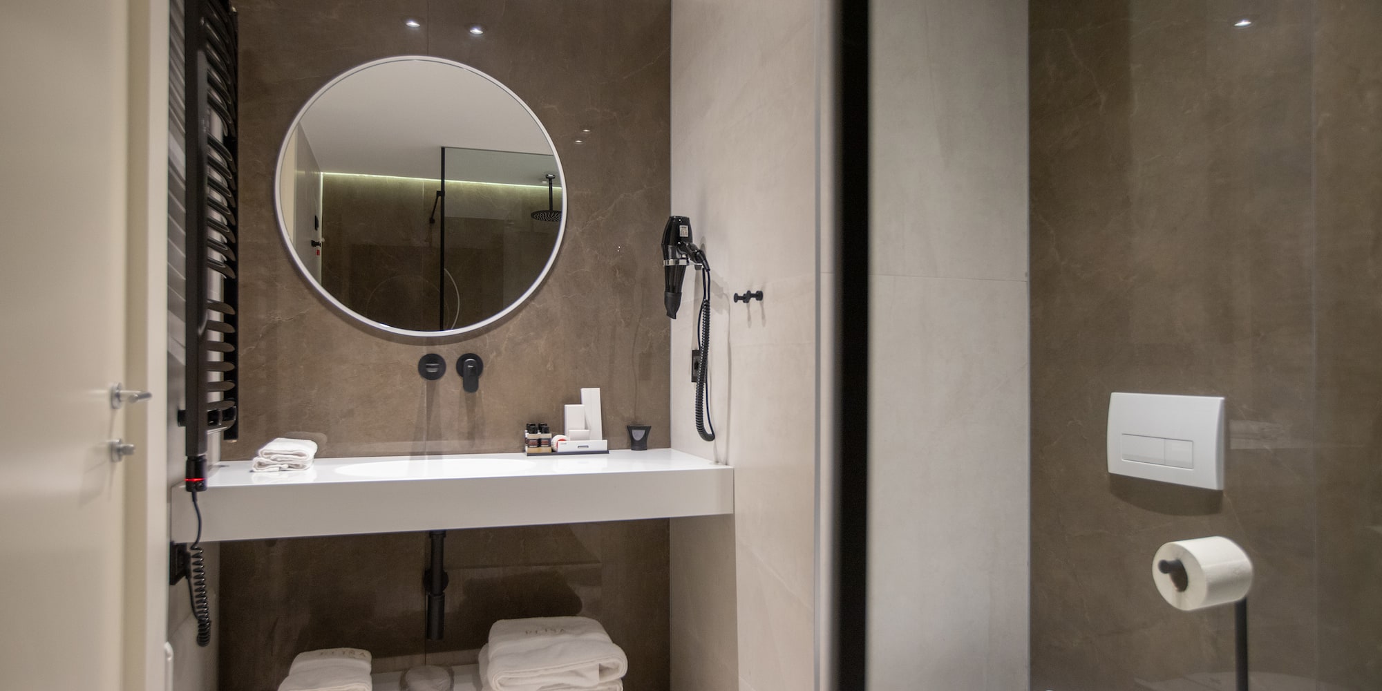 a bathroom with a round mirror