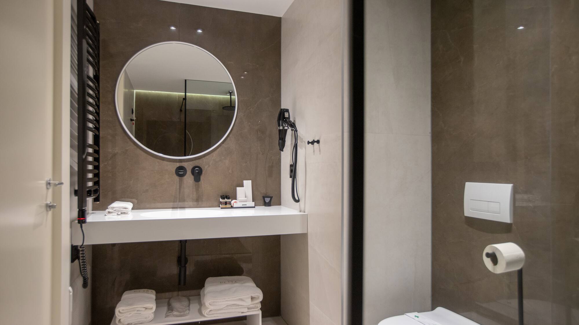 a bathroom with a round mirror