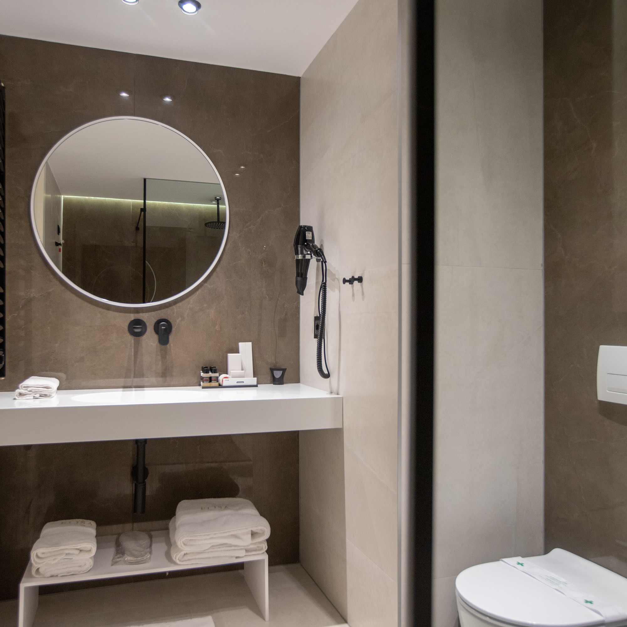 a bathroom with a round mirror