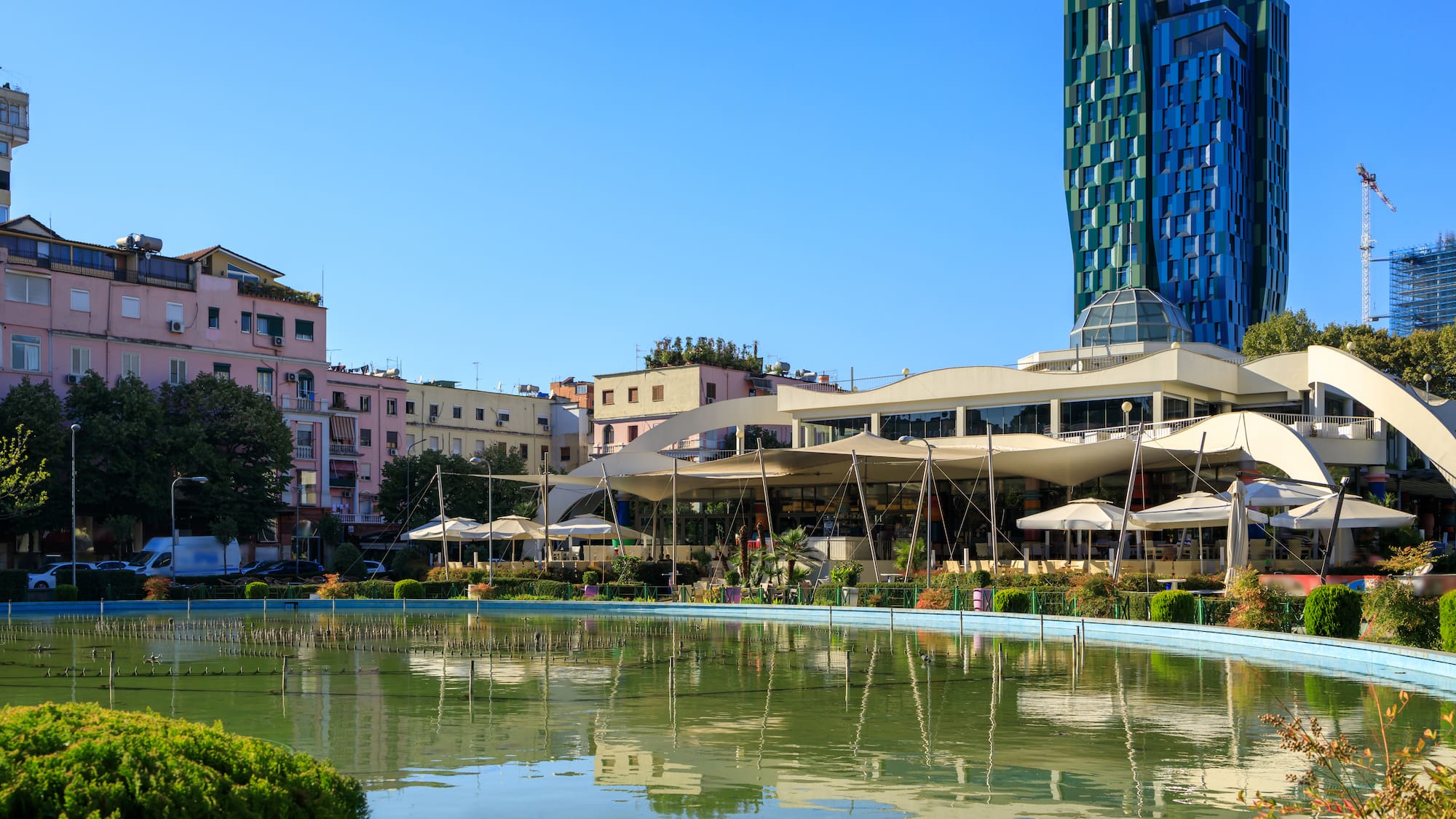 a pool of water with buildings in the background