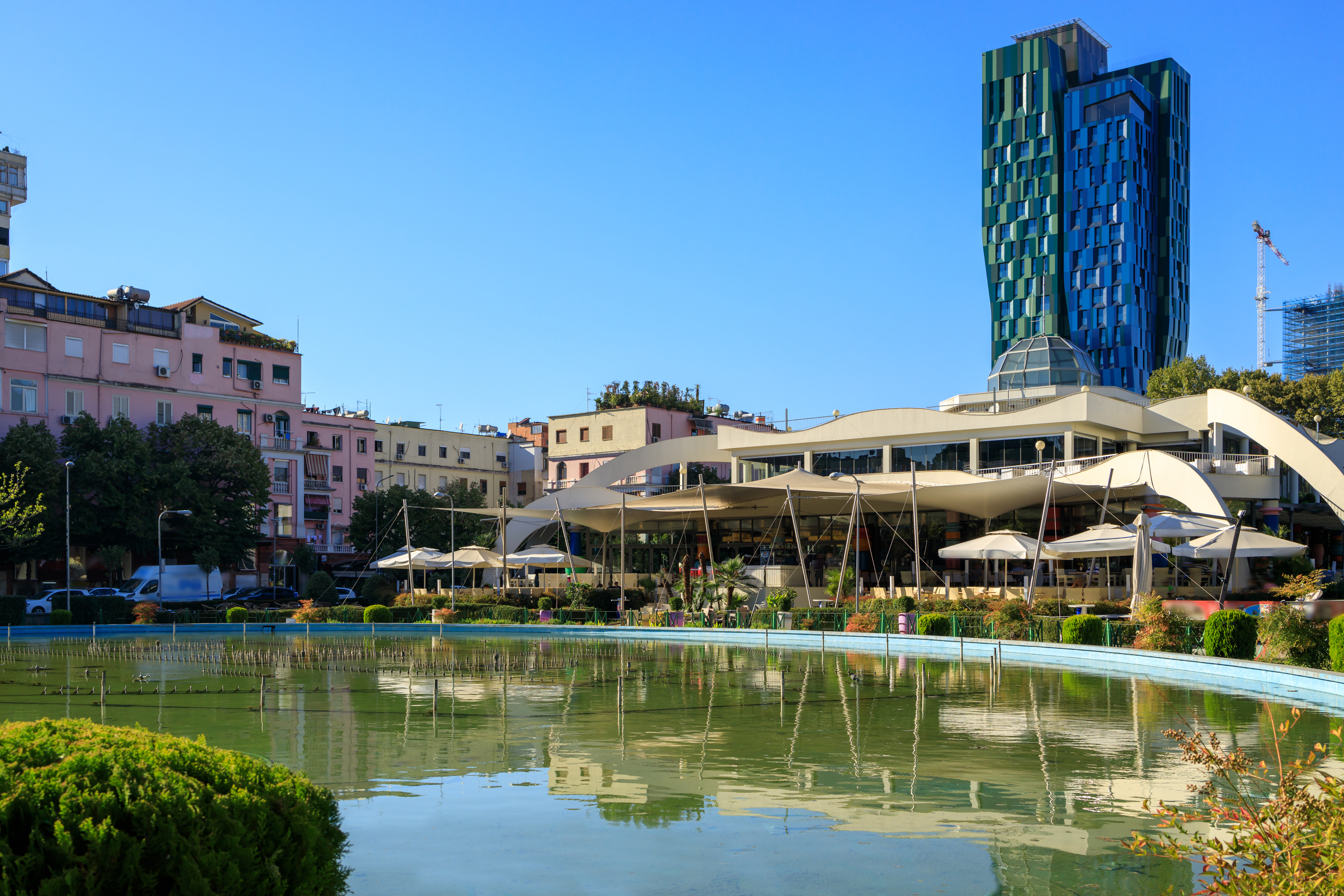 a pool of water with buildings in the background