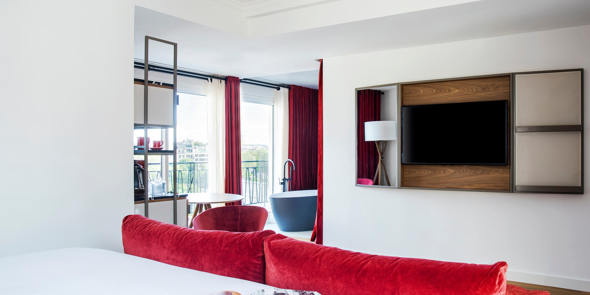 a room with red curtains and a bed