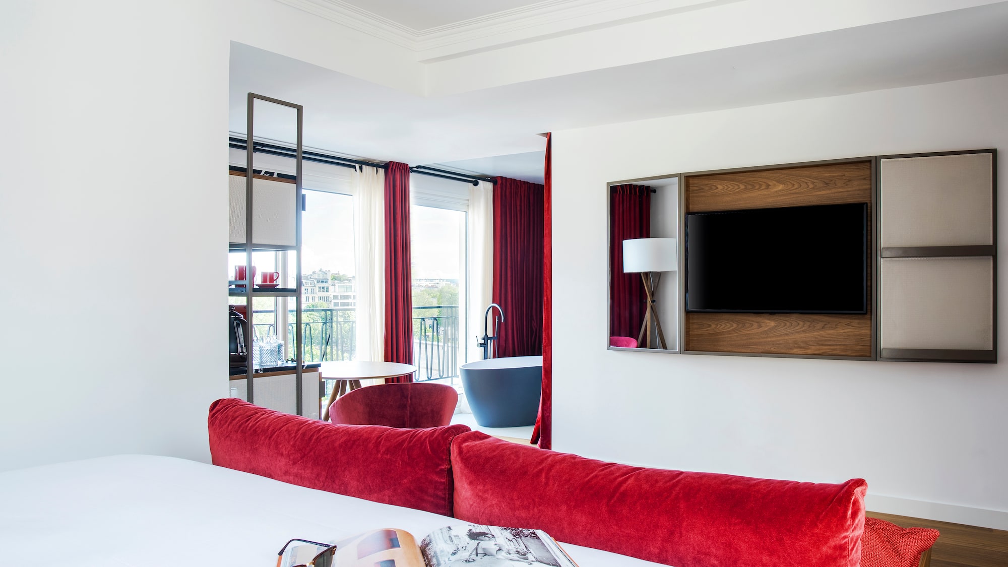 a room with red curtains and a bed
