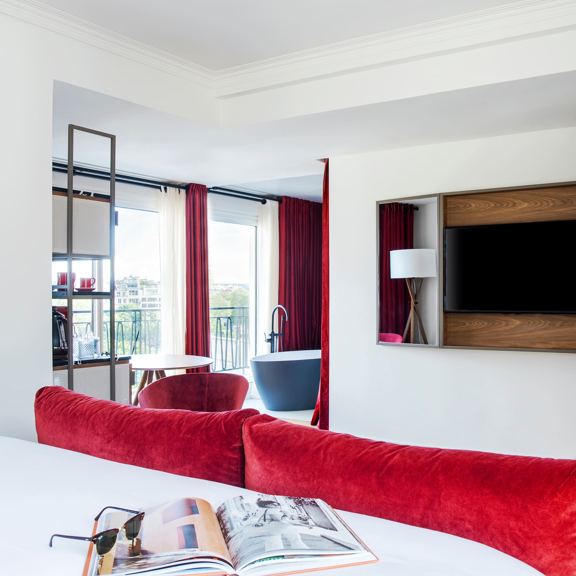 a room with red curtains and a bed