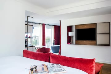 a room with red curtains and a bed