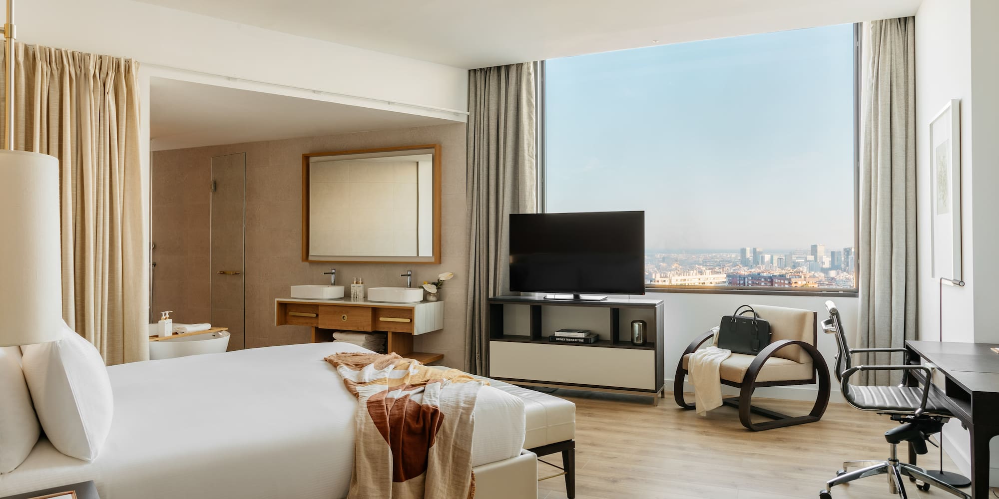 a room with a large window and a large bed