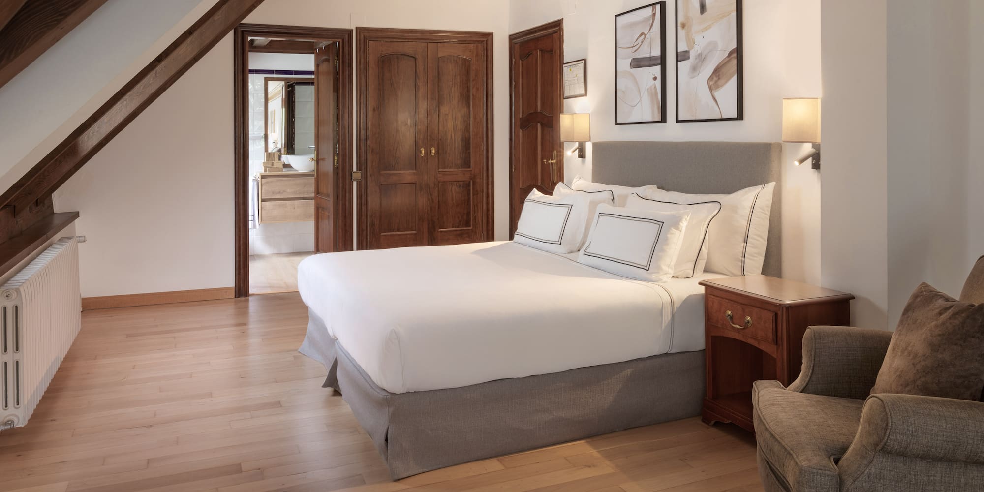 a bedroom with a bed and a chair