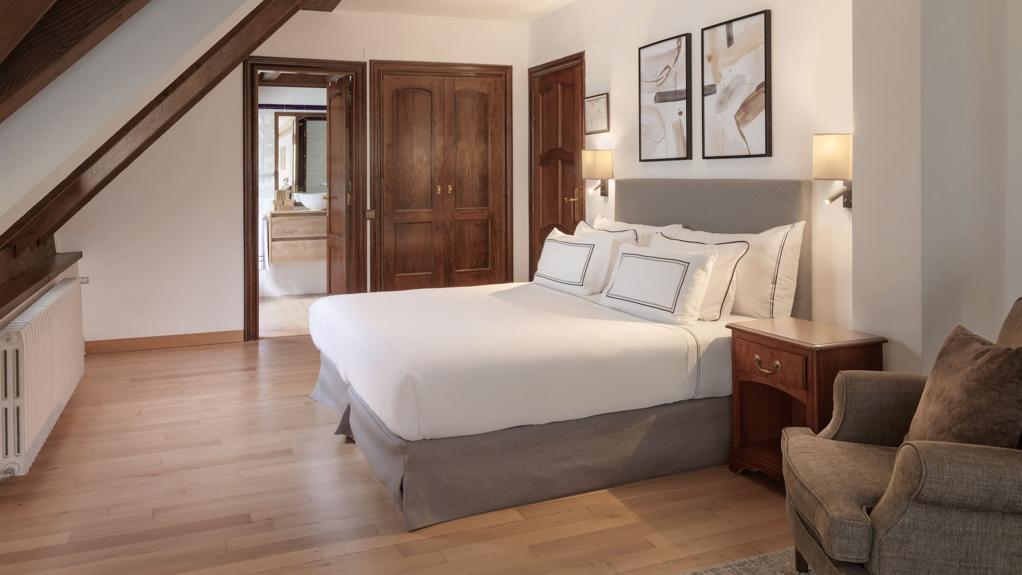 a bedroom with a bed and a chair