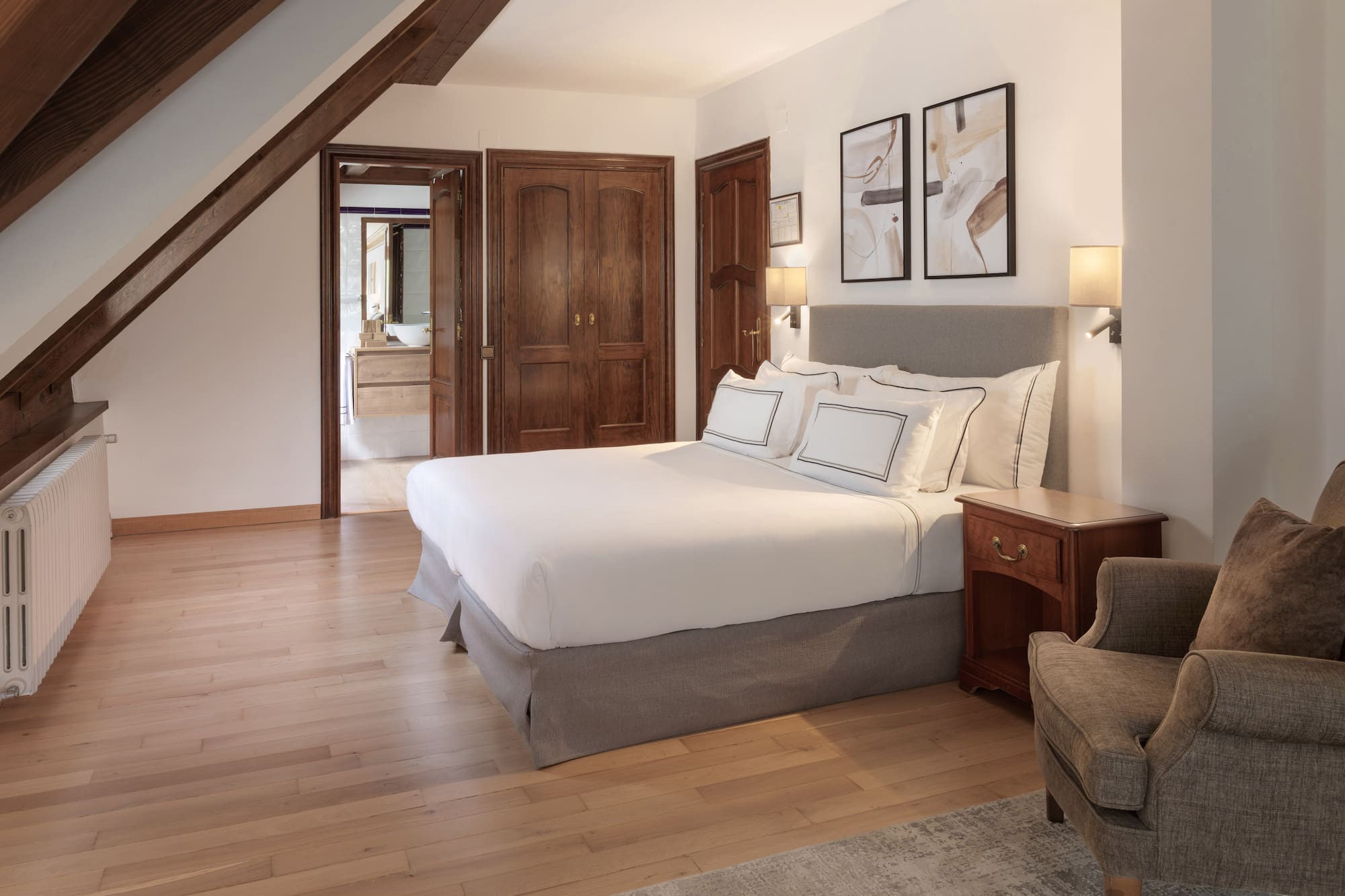 a bedroom with a bed and a chair