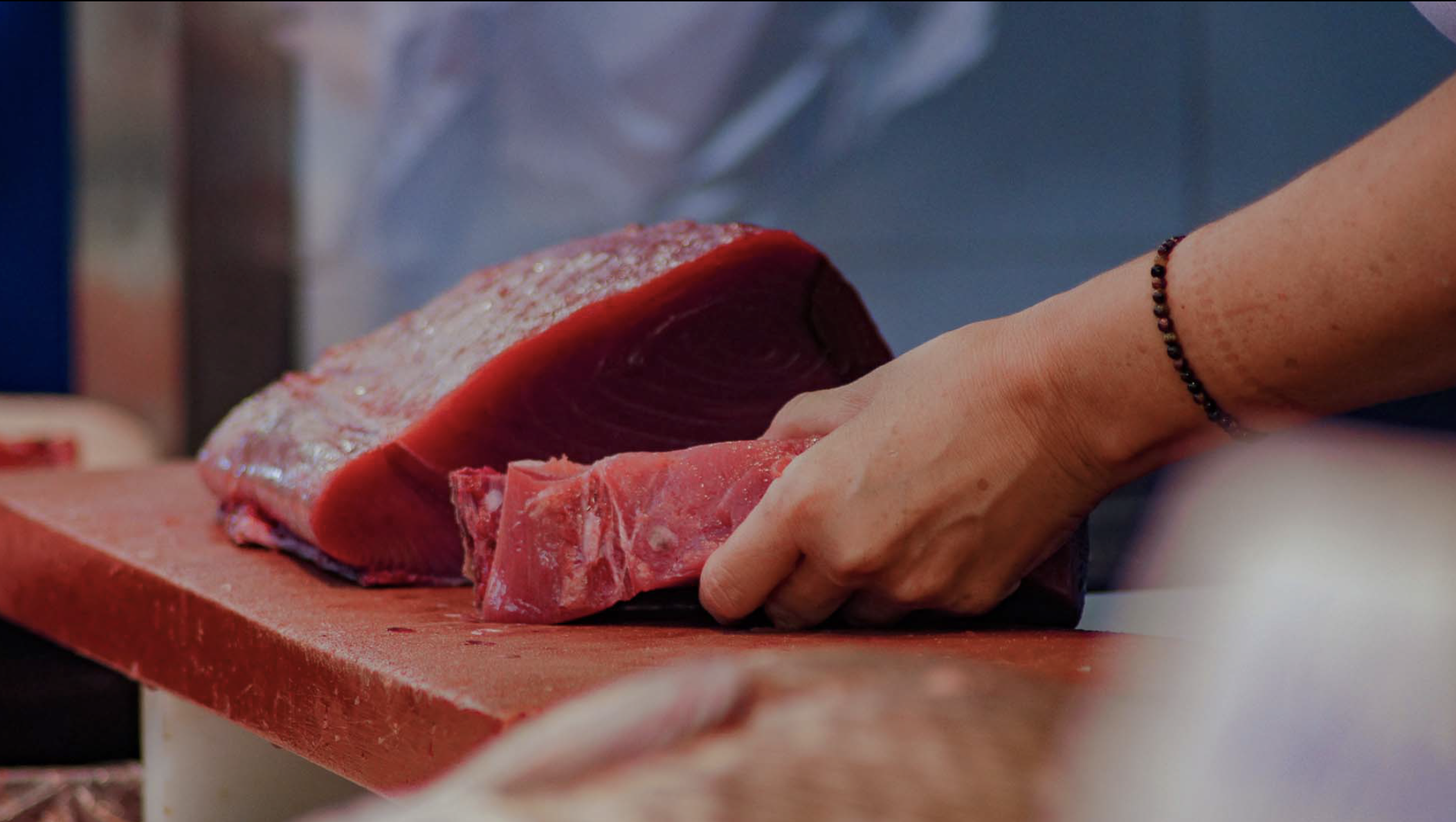 a person cutting a piece of meat