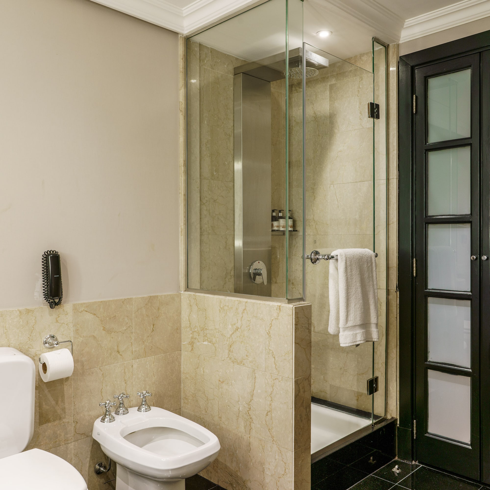 a bathroom with a glass shower and toilet