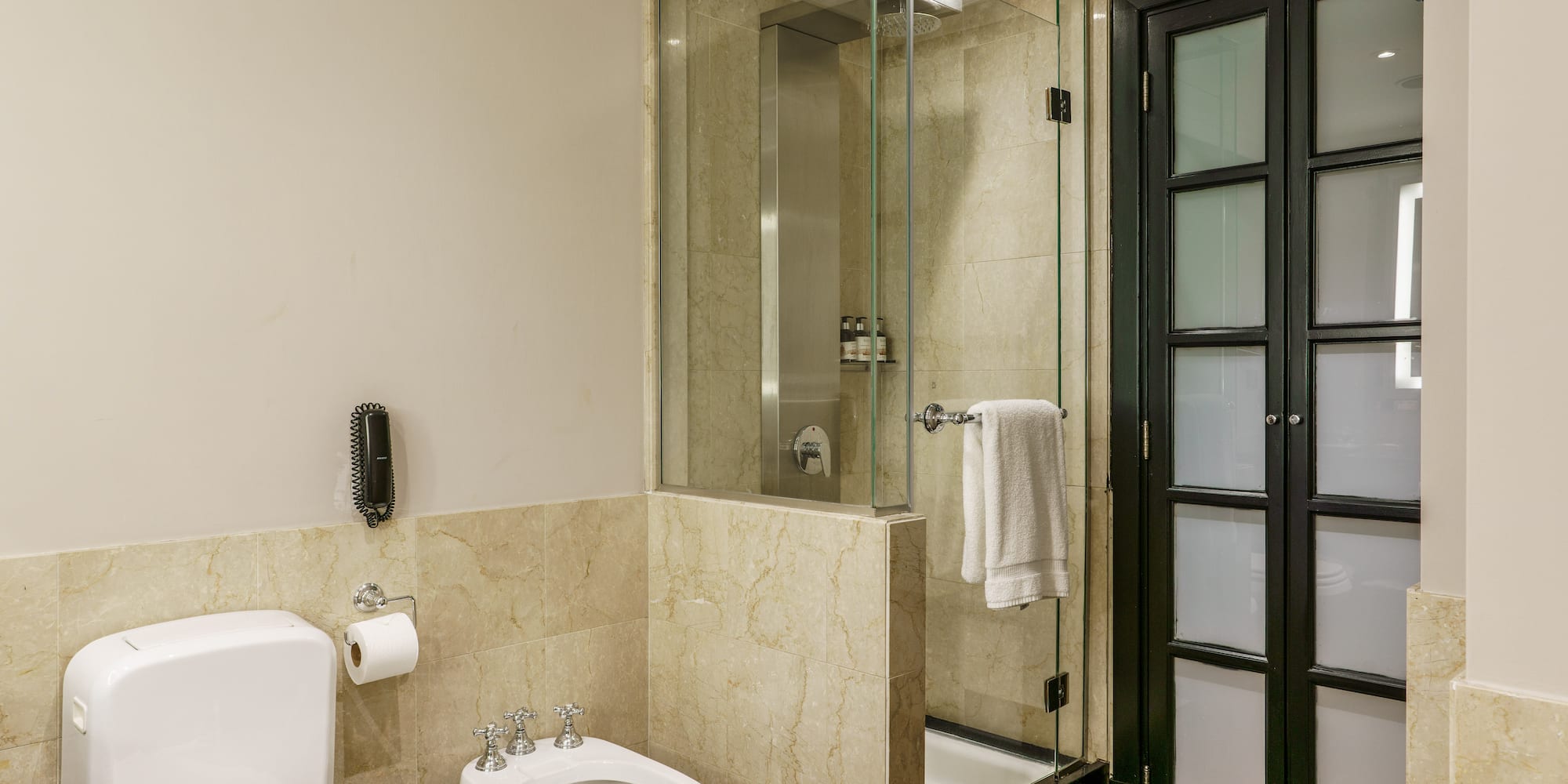 a bathroom with a glass shower and toilet