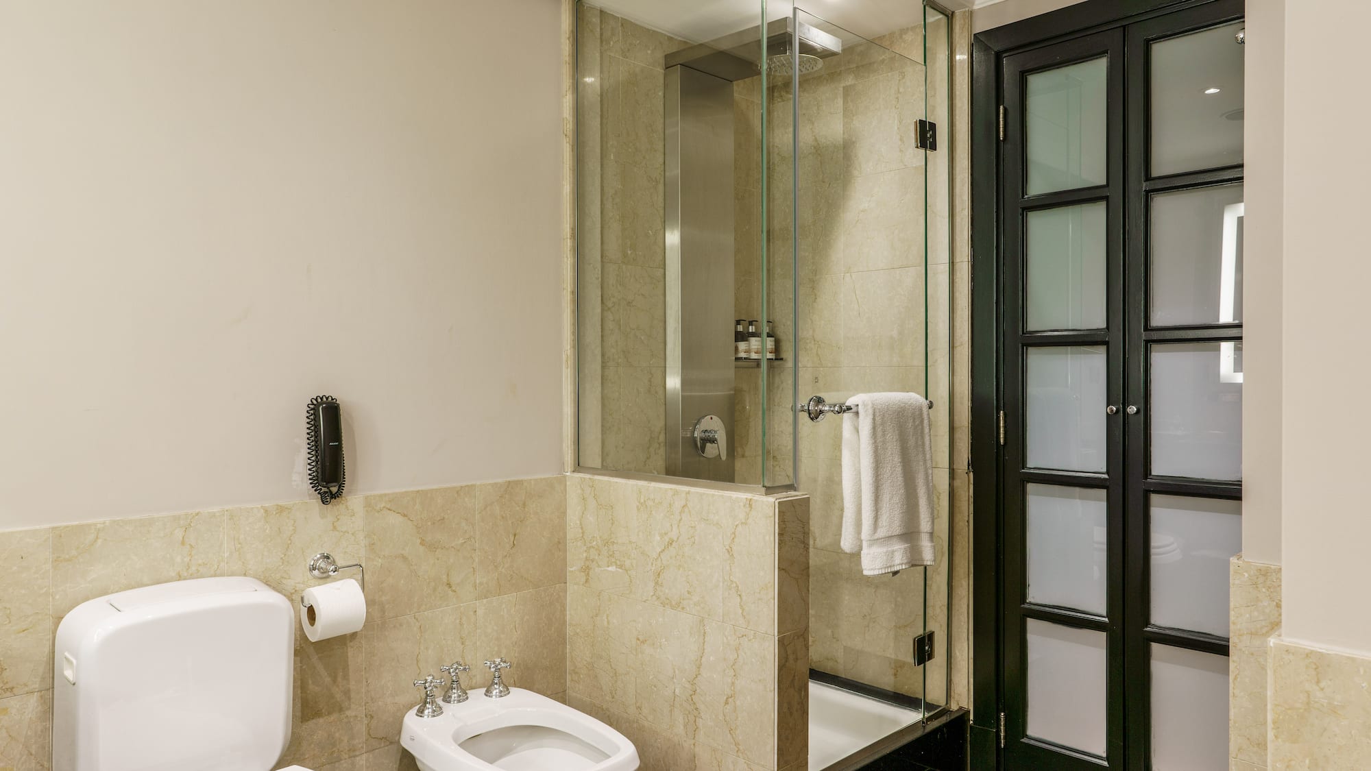 a bathroom with a glass shower and toilet