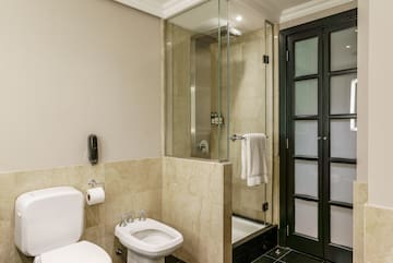 a bathroom with a glass shower and toilet