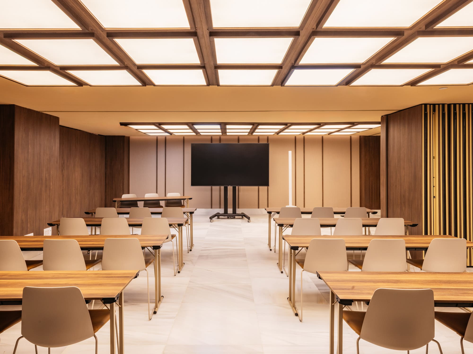 a room with desks and a screen