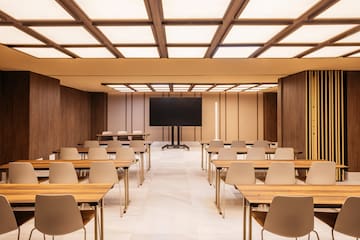 a room with desks and a screen