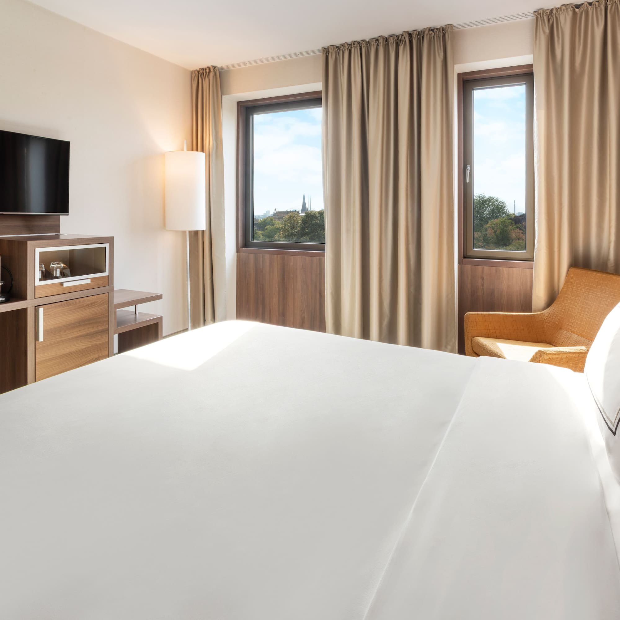 a room with a bed and a television