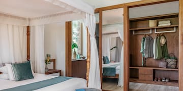Premium Terrace room with a bed and closets at Melia Zanzibar Hotel