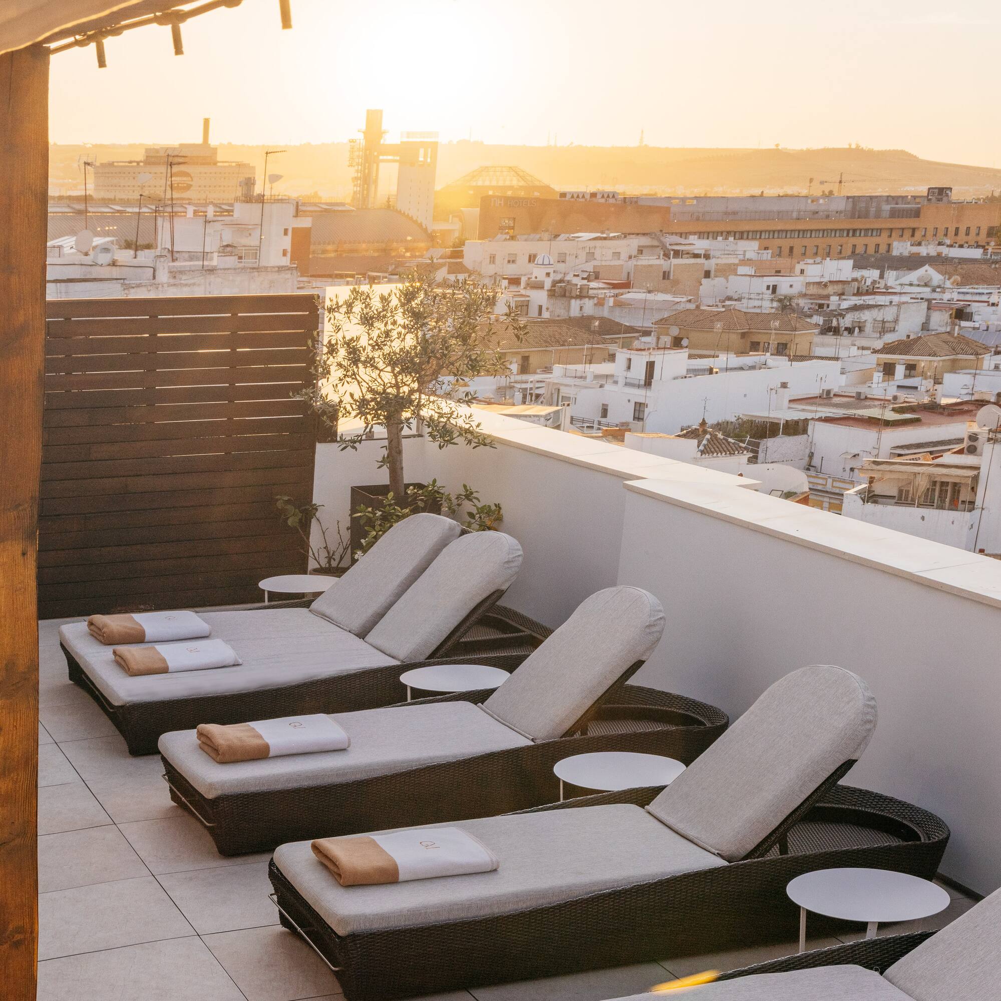 a group of lounge chairs on a rooftop