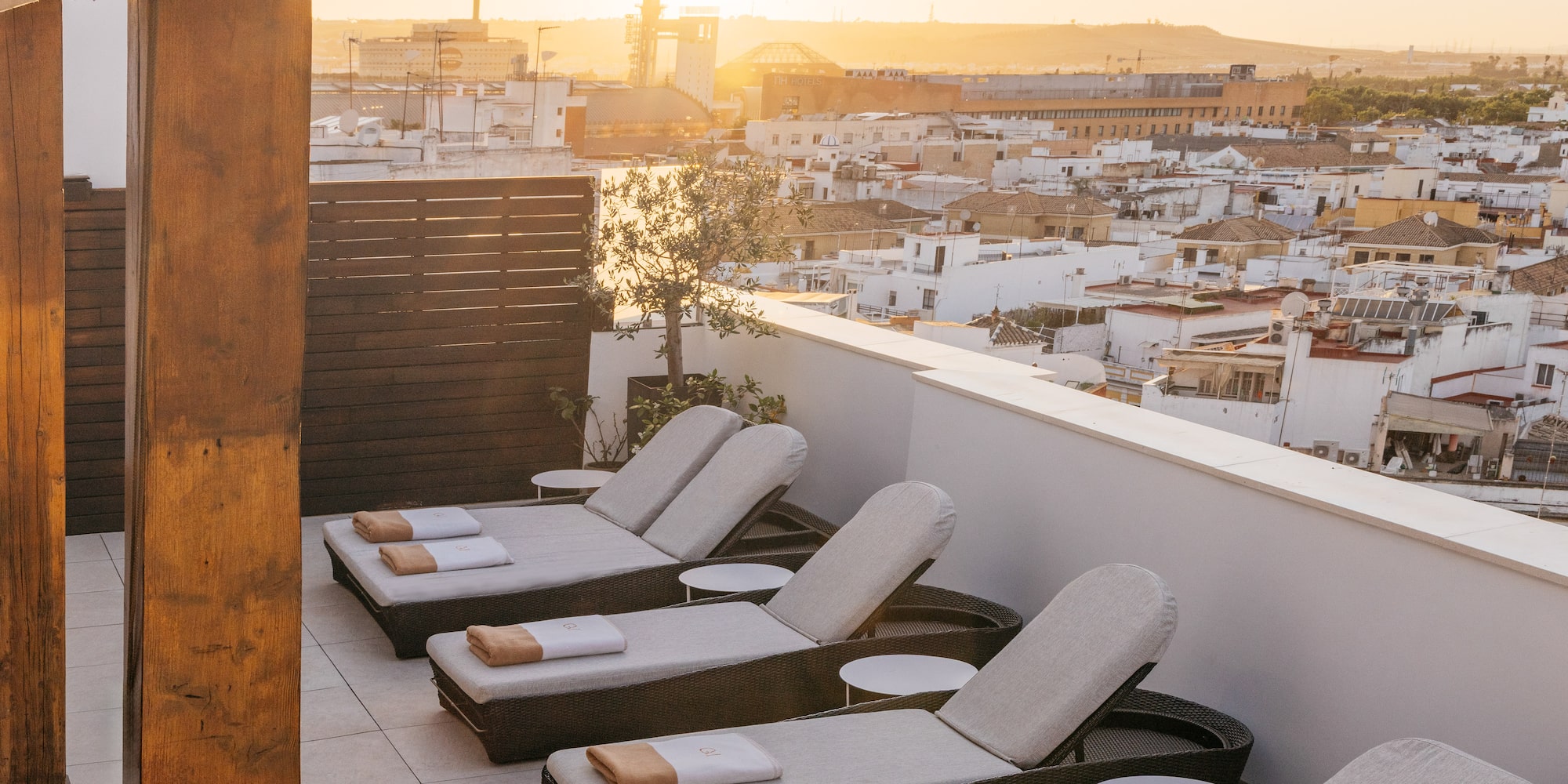 a group of lounge chairs on a rooftop