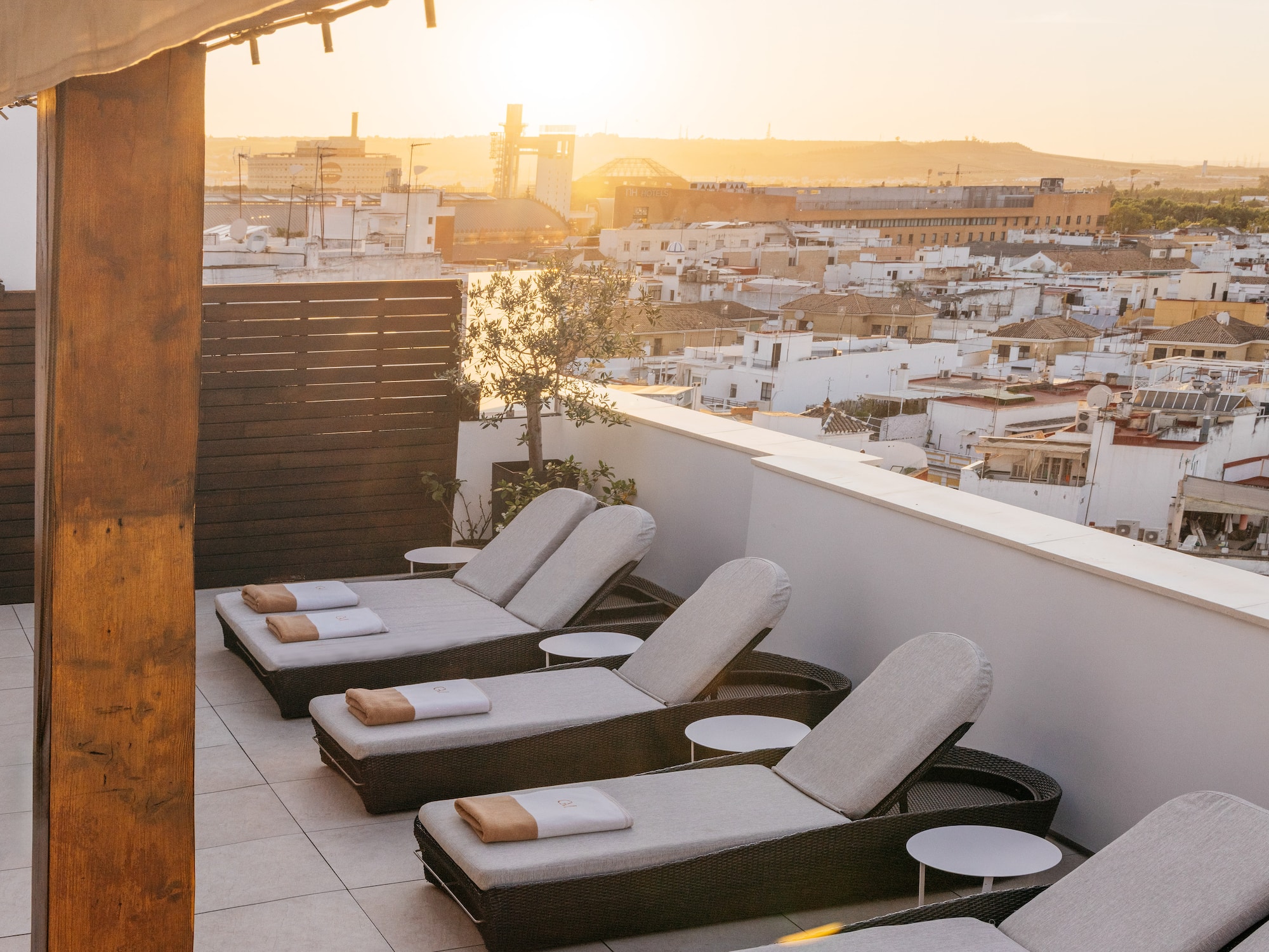 a group of lounge chairs on a rooftop