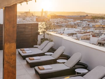 a group of lounge chairs on a rooftop