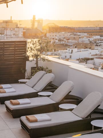 a group of lounge chairs on a rooftop
