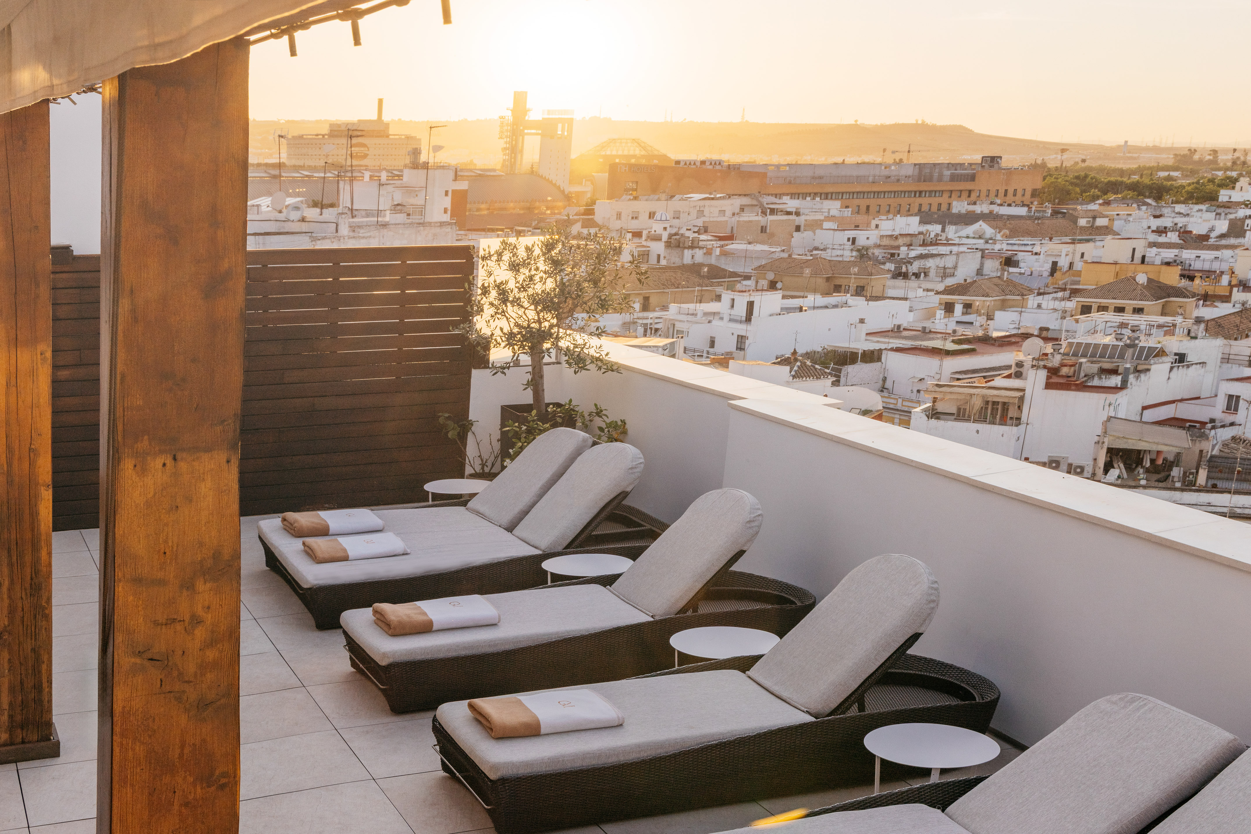 a group of lounge chairs on a rooftop