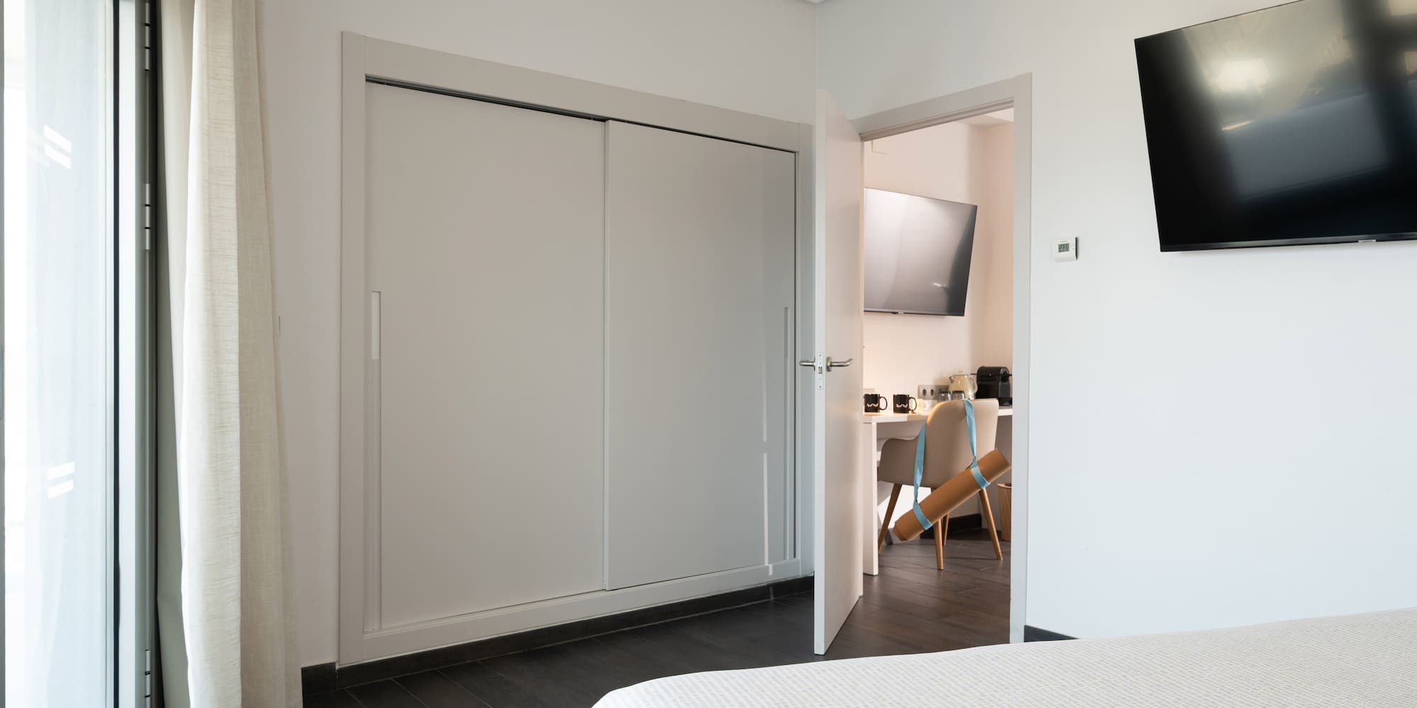 a room with a tv and a bed