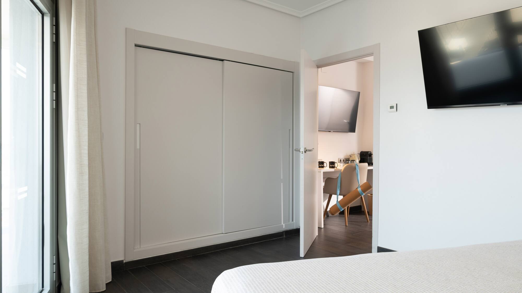 a room with a tv and a bed