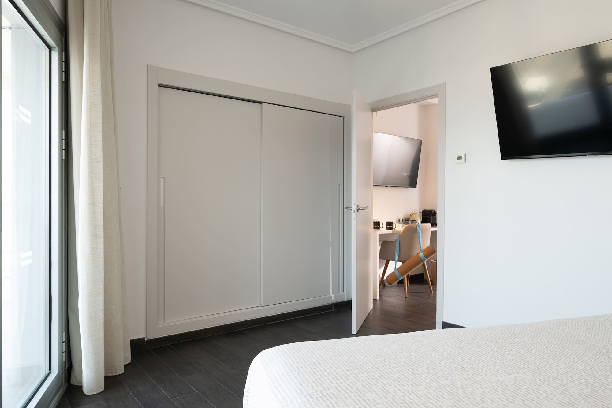 a room with a tv and a bed