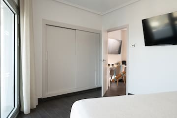 a room with a tv and a bed