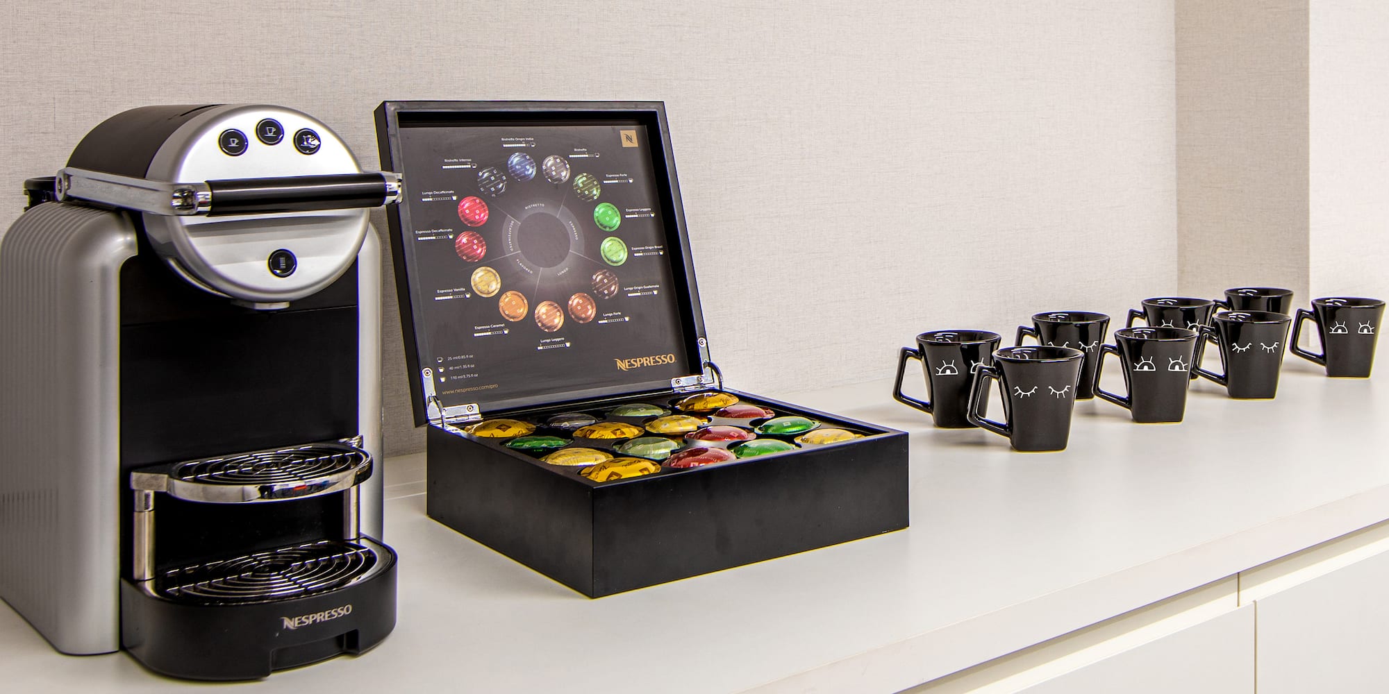 a coffee machine and coffee cups on a counter