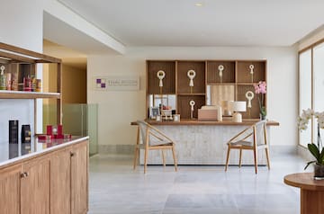 a room with a desk and chairs