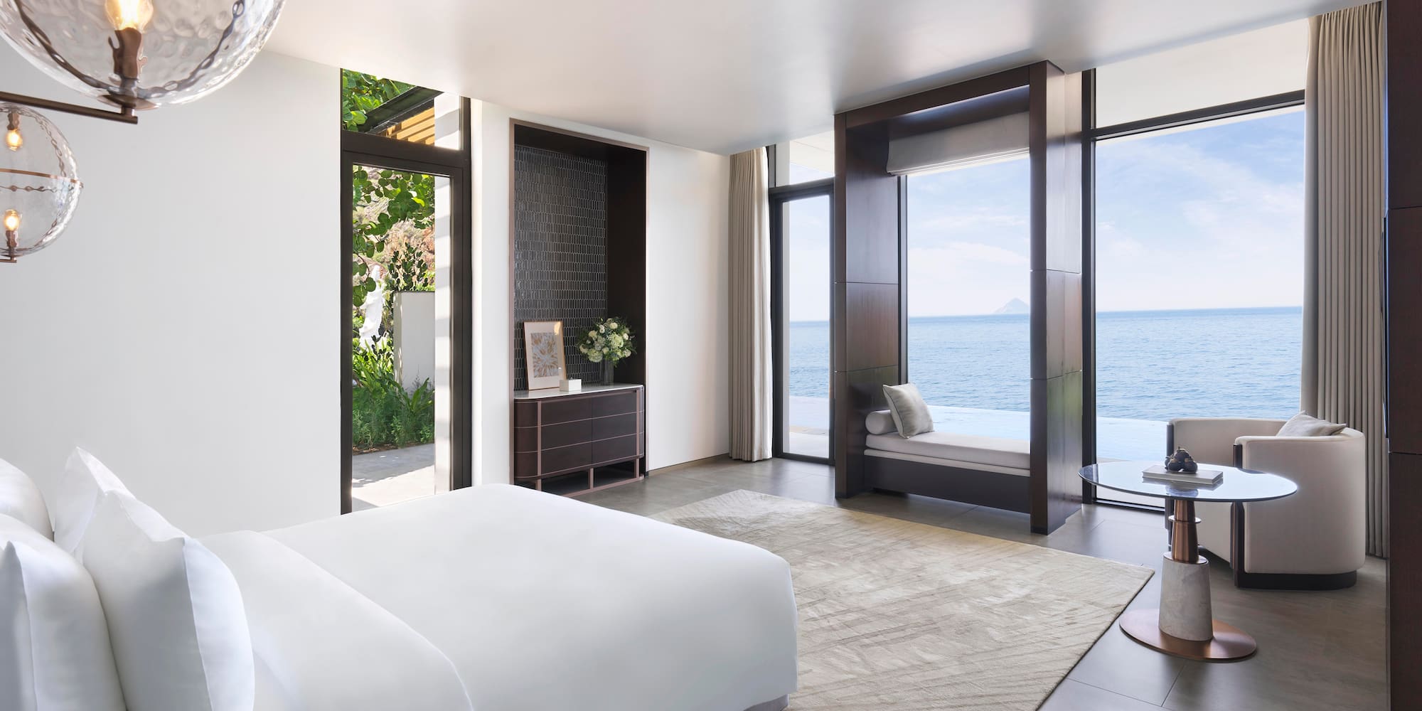 a bedroom with a view of the ocean