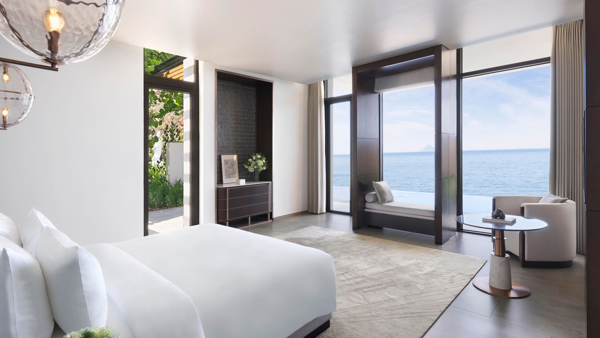 a bedroom with a view of the ocean