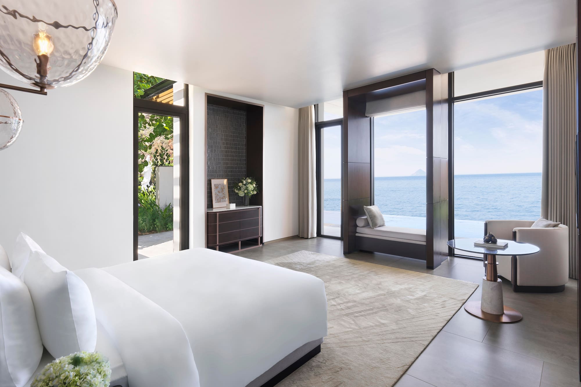 a bedroom with a view of the ocean